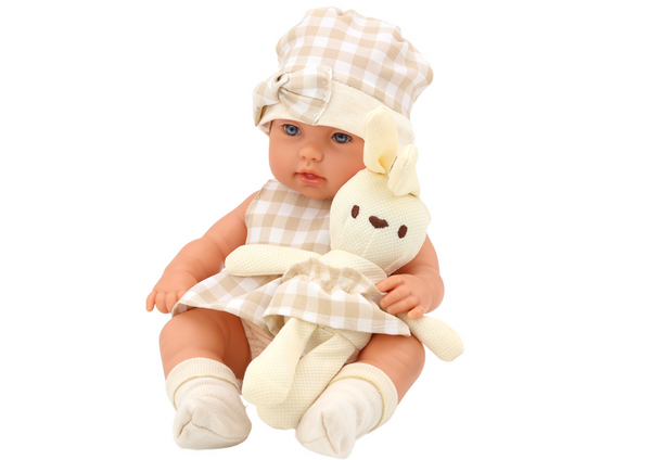 Baby doll in a carrier, a bunny, in a checkered outfit, beige